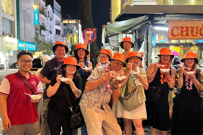 Saigon By Night: Authentic Street Food Scooter Adventure - District 1 meet-up: English guide, helmet time, and a quick safety rhythm